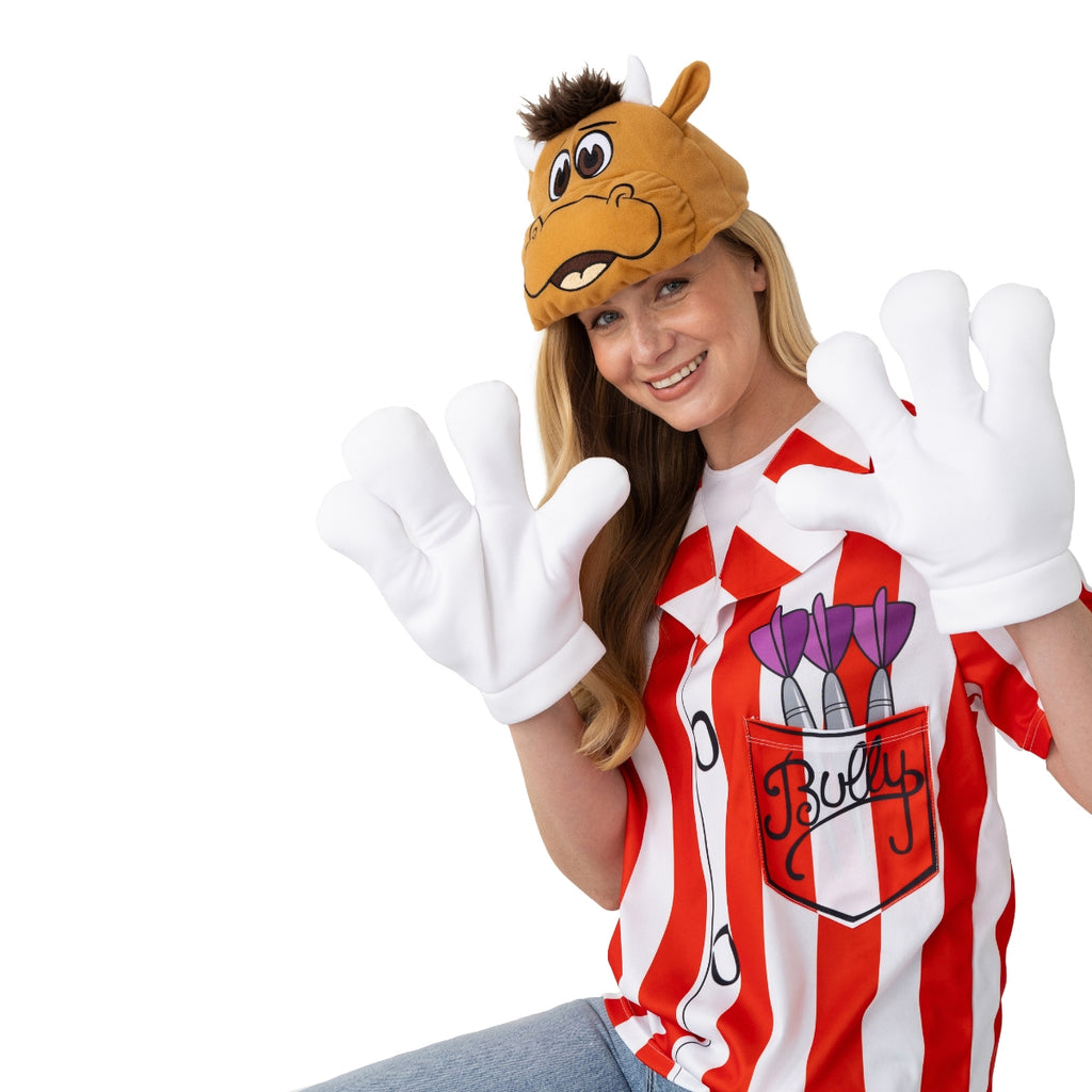 A smiling woman wears the Professional Darts Corporation Bullseye Adult Bully Shirt with Padded Head and Padded Gloves, featuring a red-and-white striped "Bully" shirt and cartoon bull hat, waving her hands against a white background.