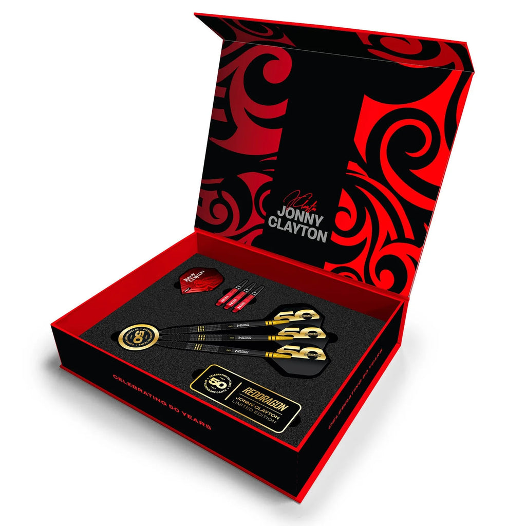 The Professional Darts Corporation’s Jonny Clayton 50 Year Player Edition Box features three 90% tungsten darts, spare red-and-black flights, a gold badge, and a certificate, all arranged in a custom black and red foam box.