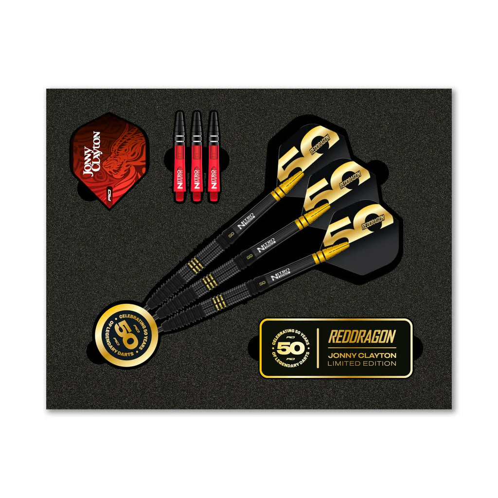 The Jonny Clayton 50 Year Player Edition Box by Professional Darts Corporation includes three limited edition gold and black 90% tungsten darts, three spare flights, three extra stems, two 50th anniversary tokens, and a foam display case.