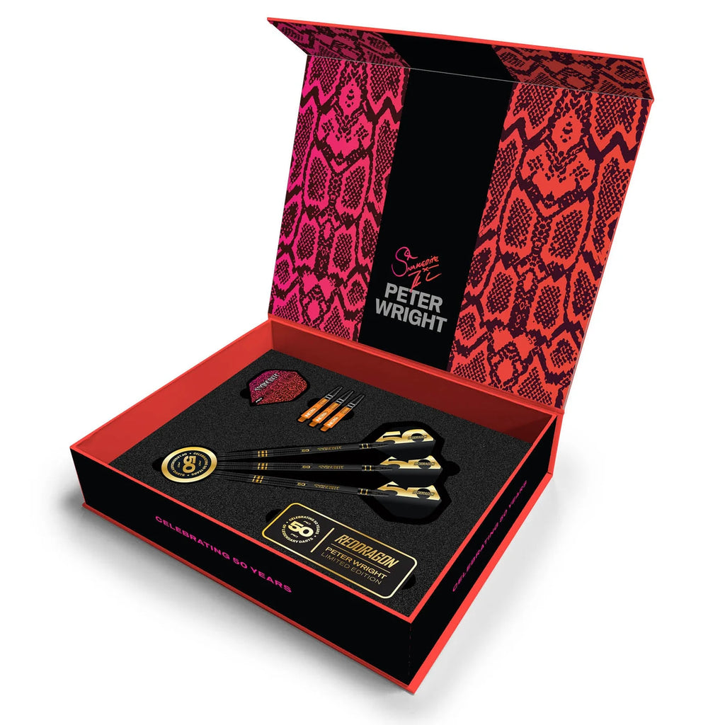 The Peter Wright 50 Year Player Edition Box by Professional Darts Corporation includes three black and gold Snakebite darts, extra flights, a case, and an accessory card in a stylish pink snakeskin-lid box celebrating the pro player.
