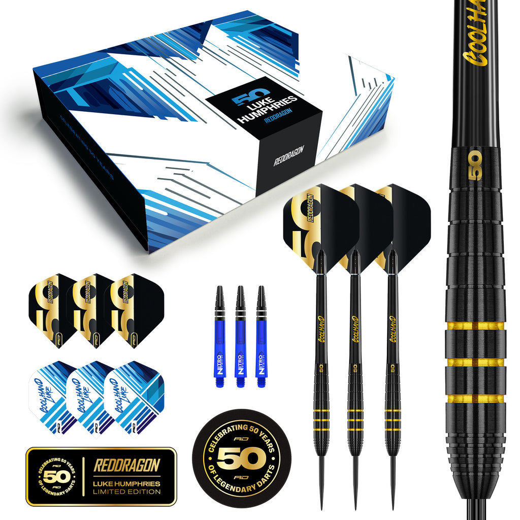 The Professional Darts Corporation's Luke Humphries 50 Year Player Edition Box includes three black and gold darts, extra black and white flights, three blue shafts, a branded box, and anniversary logo stickers.