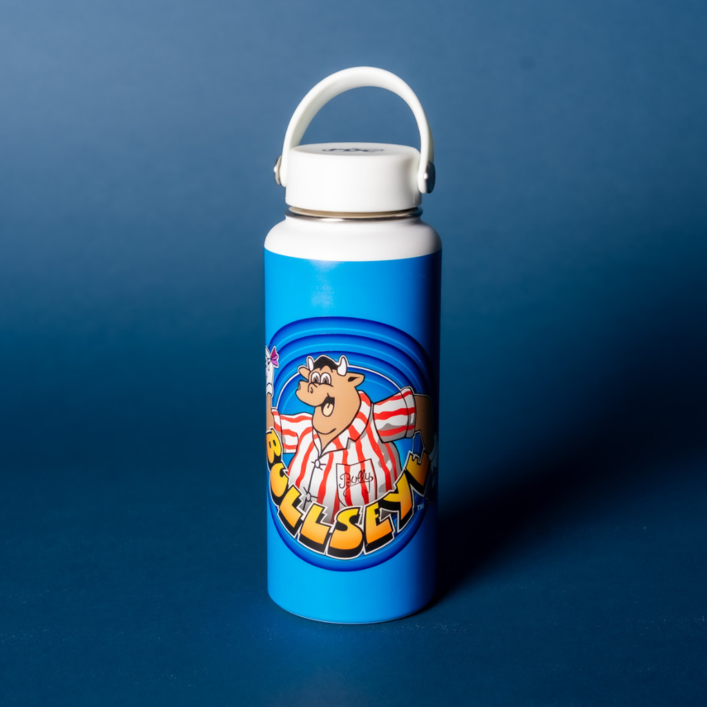The Bullseye Thermal Flask by Professional Darts Corporation is a white sports water bottle with a blue label showing a cartoon bull in a red and white striped shirt and “BULLSEYE” in bold yellow text, set on a plain blue background.