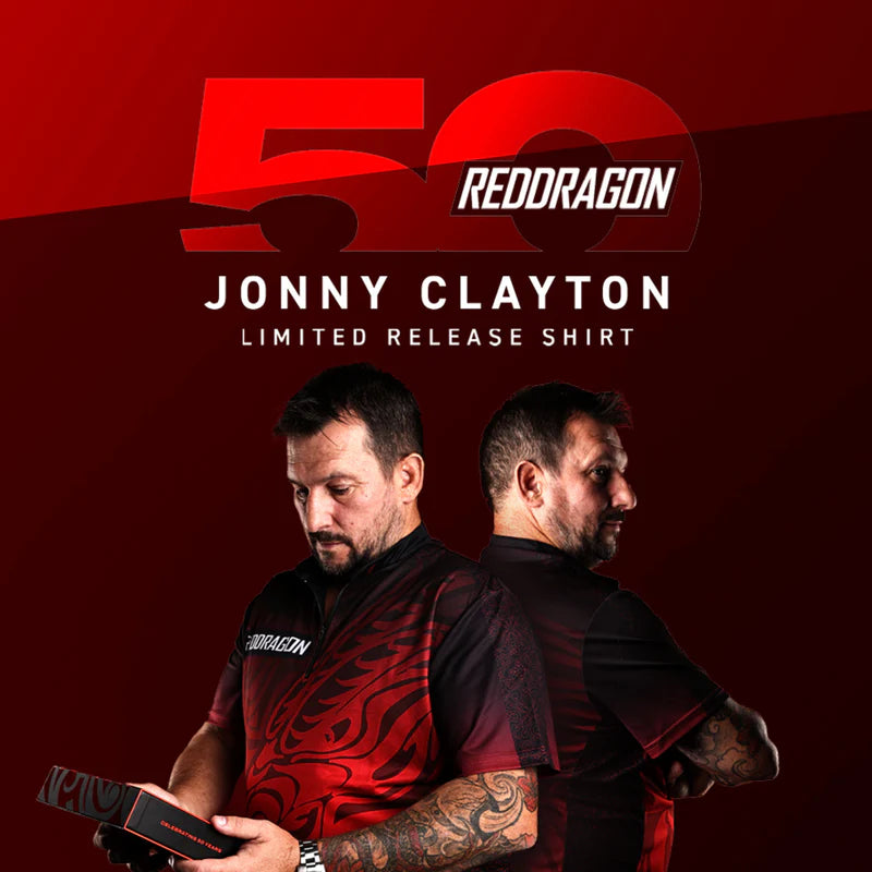 Jonny Clayton shows off the Professional Darts Corporation's Jonny Clayton 50 Year Player Edition Shirt on a red backdrop, celebrating the exclusive collector's release.